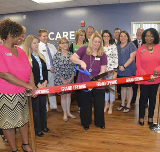 Karla Gilliam cuts the ribbon on the new CARE Planning Center at PTC.