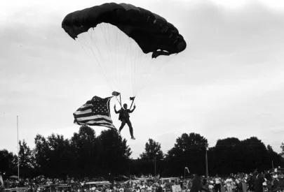 Man parachuting in during 4th of July