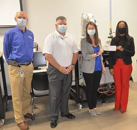 Pictured from left: Glenn McLean, Eaton Plant Manager; Travis Gunter, Eaton Materials Planning Manager; Amber DePietro, Eaton Plant Manager; Dr. Hope E. Rivers, President of PTC