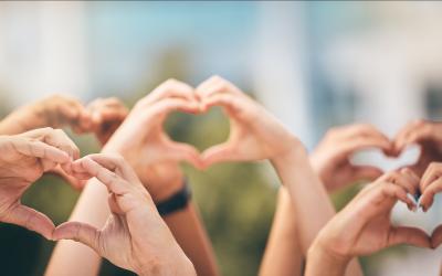 Multiple hands making the heart sign