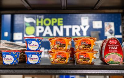 Sign for the Hope Pantry with cans in front of it