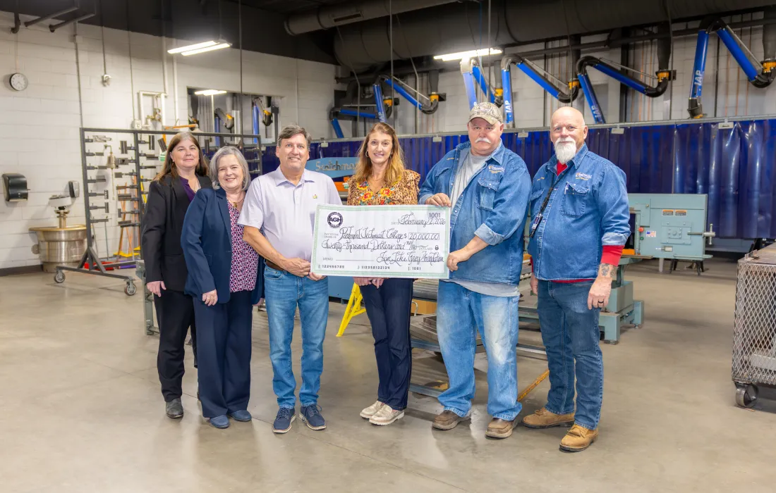 Group holding a check