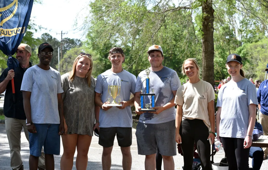 Group standing with a trophy