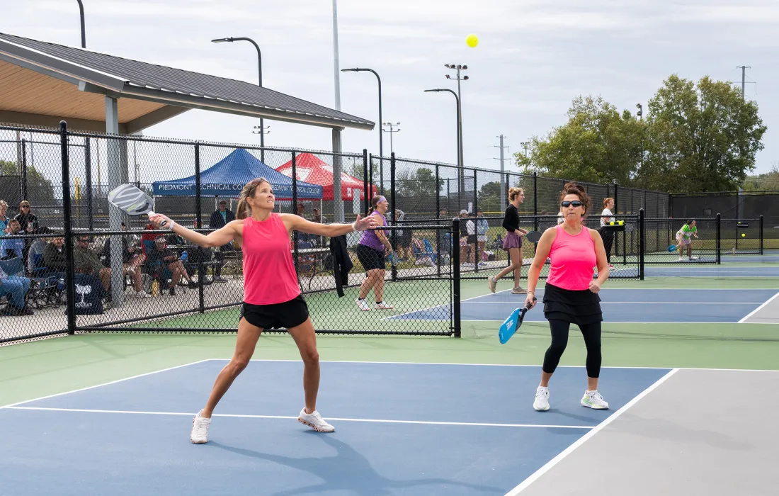 Two women playing pickleball