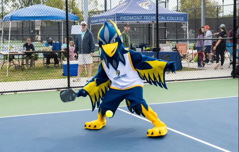 PTC mascot Blaze shows off his pickleball skills.