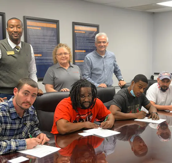 Front row, from left: James Downey, Michael Richardson, Tramonte Hill, and Barry Taylor; Back row, from left:  Alvie Coes, HR Manager Sherrie Bishop of Diana Pet Food; and Rusty Denning