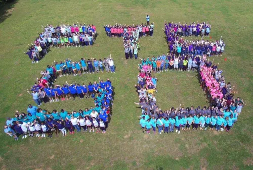 PTC 50 spelled out by students on a lawn