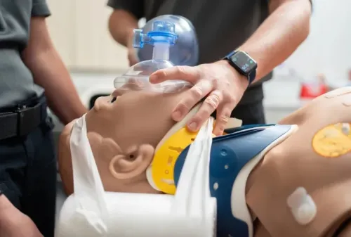 Paramedic students working with dummy