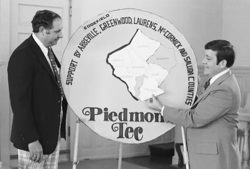 Men posing by poster