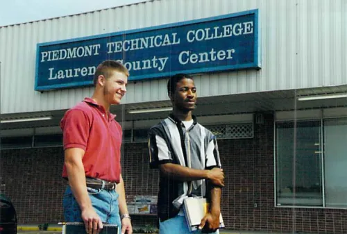 Men posing in front of PTC center