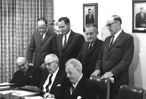 Board members gathered by table